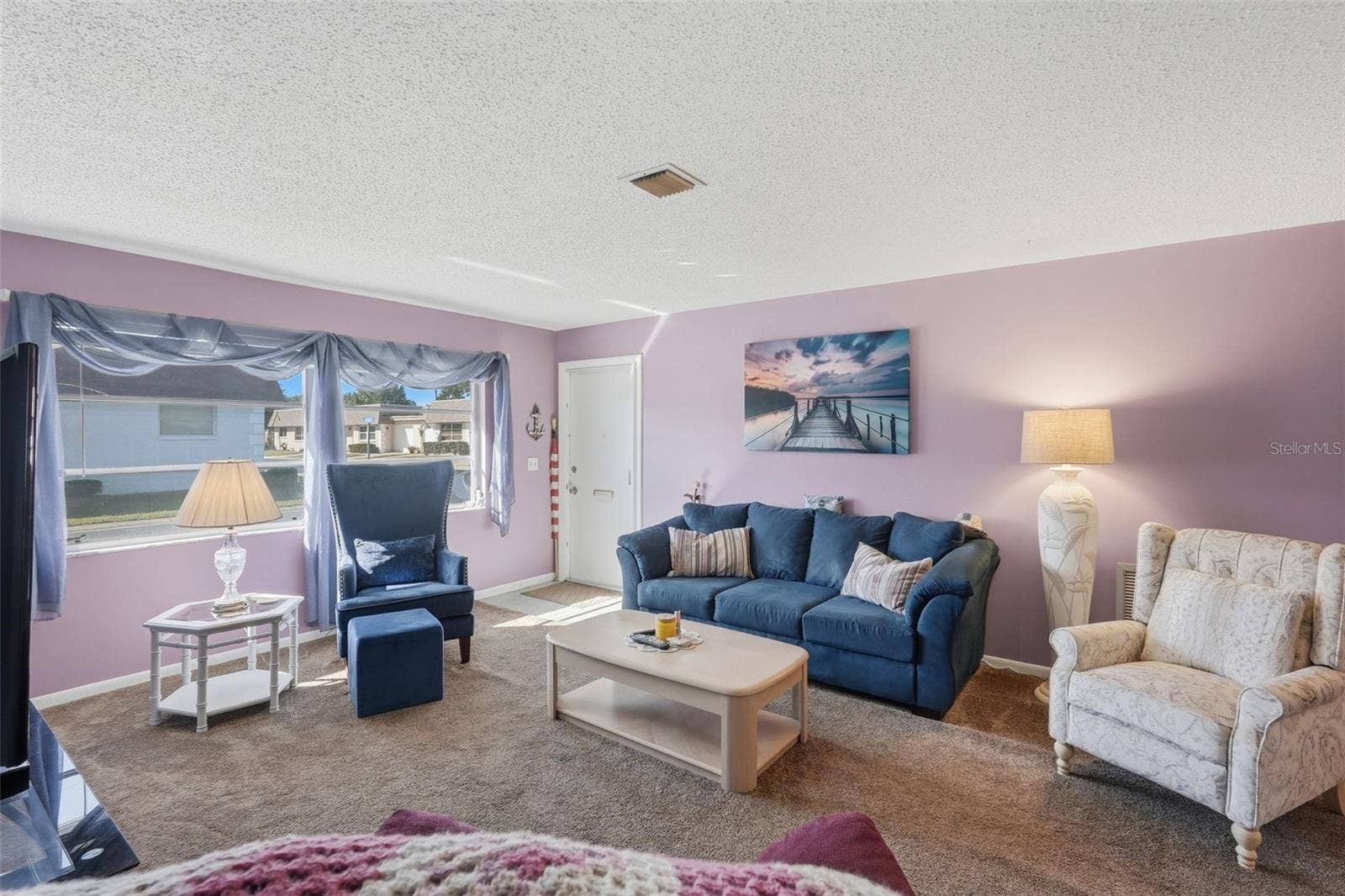7035 MONTE CARLO N, Pinellas Park, FL 33781 Another view of the bright living room with large windows and natural light.