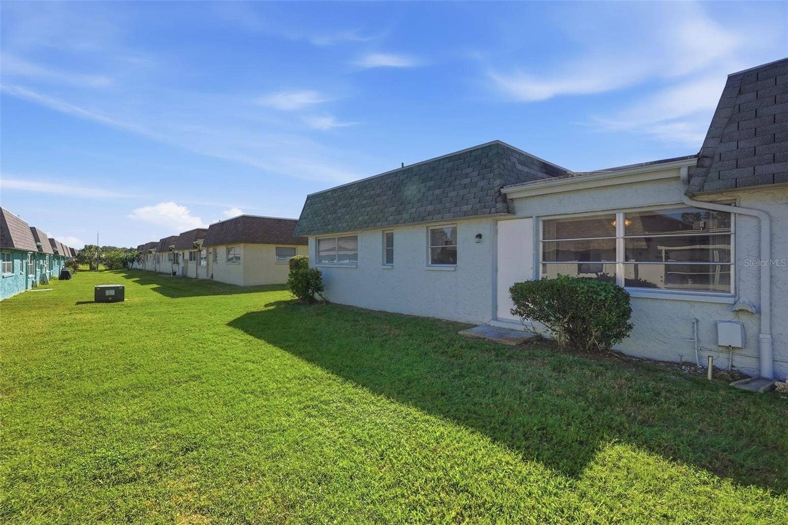 7035 MONTE CARLO N, Pinellas Park, FL 33781 Additional exterior view with green space surrounding the residence.