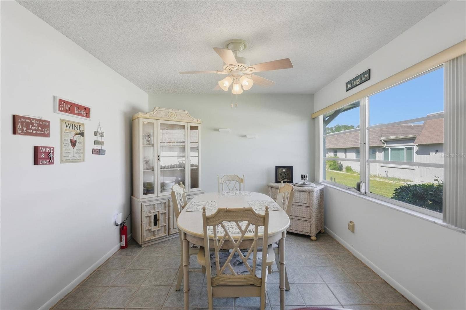 7035 MONTE CARLO N, Pinellas Park, FL 33781 Sunny dining area with large windows and ceiling fan.