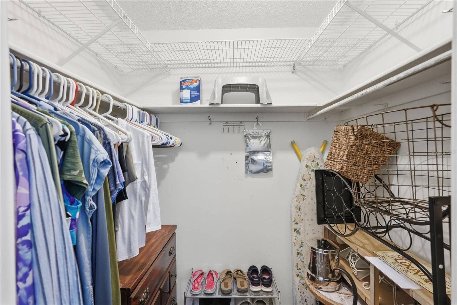7035 MONTE CARLO N, Pinellas Park, FL 33781 Interior closet with hanging space and shelving for organized storage.