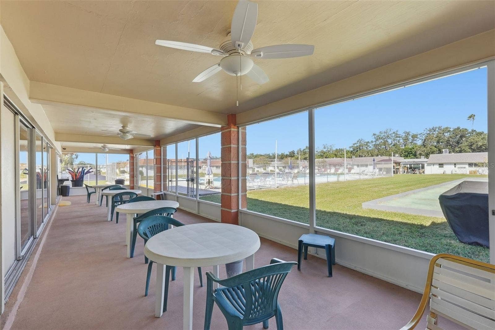 7035 MONTE CARLO N, Pinellas Park, FL 33781 Covered community patio with shaded seating and views of the recreation area.