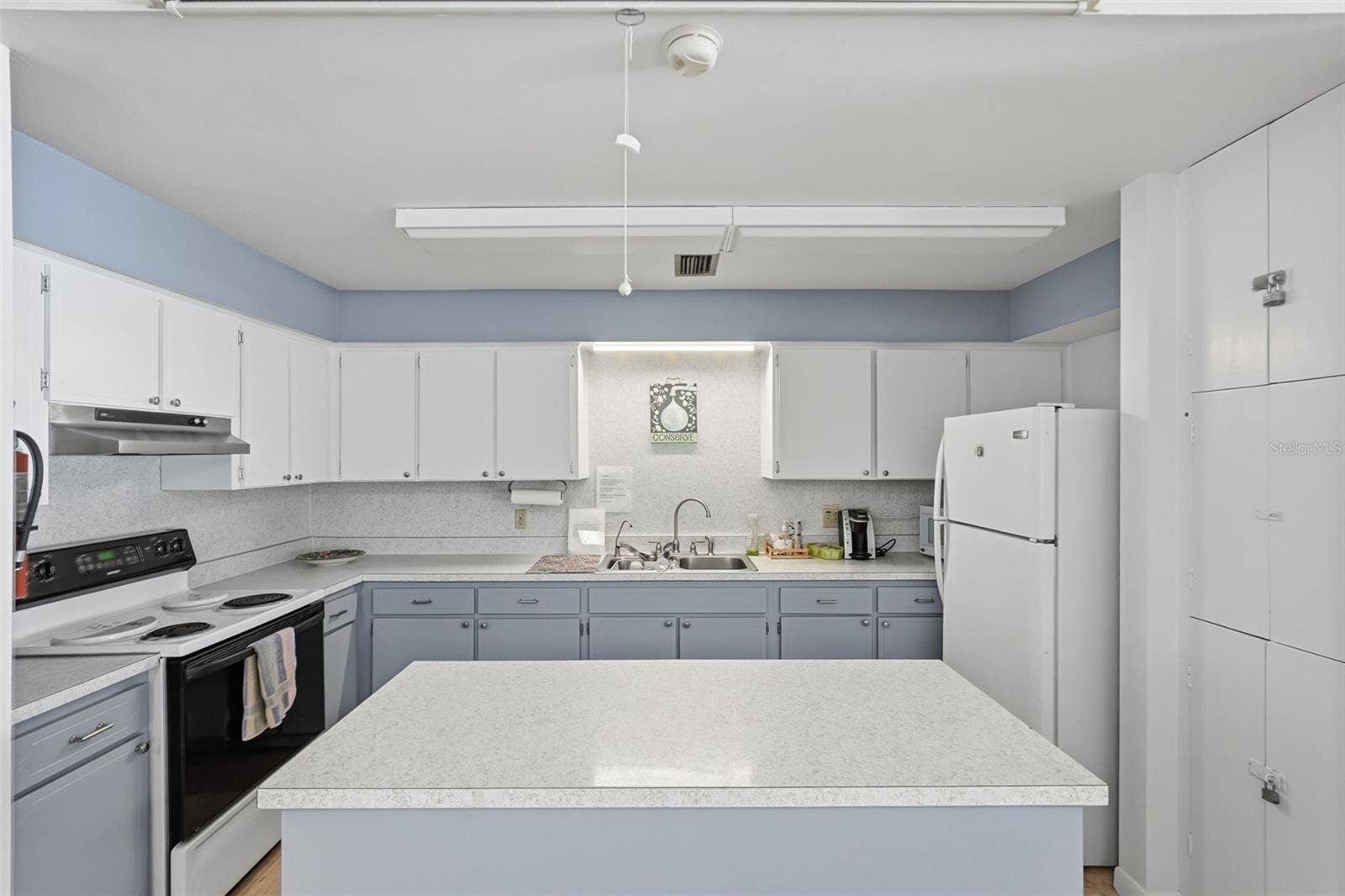 7035 MONTE CARLO N, Pinellas Park, FL 33781 Community clubhouse kitchen for resident gatherings and activities.