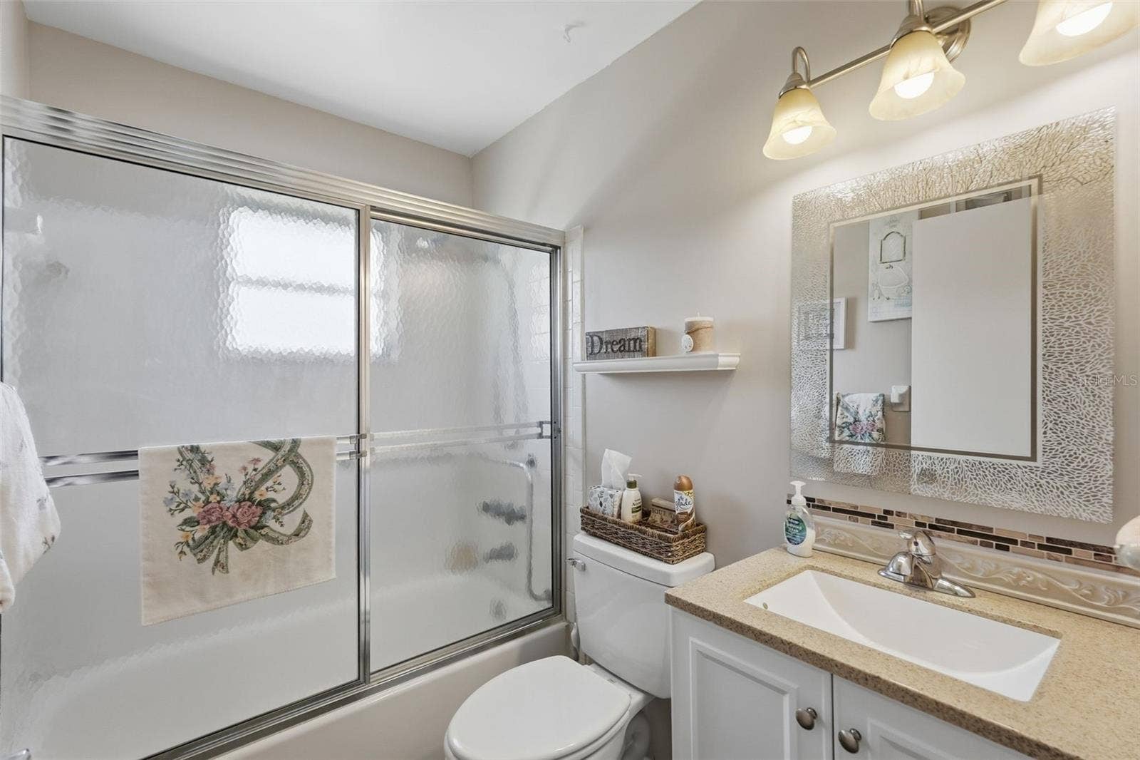 7035 MONTE CARLO N, Pinellas Park, FL 33781 Bathroom 2 features a single-sink vanity and glass-enclosed shower.