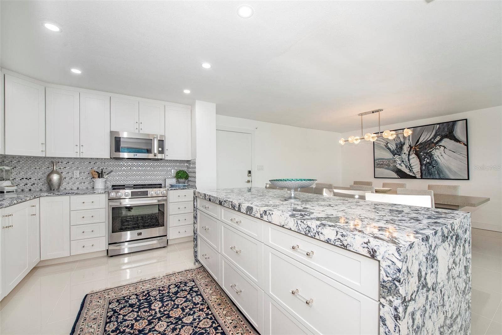 675 S GULFVIEW BOULEVARD, #704, Clearwater, FL 33767 Kitchen has an open layout and center island with buffet seating for four...