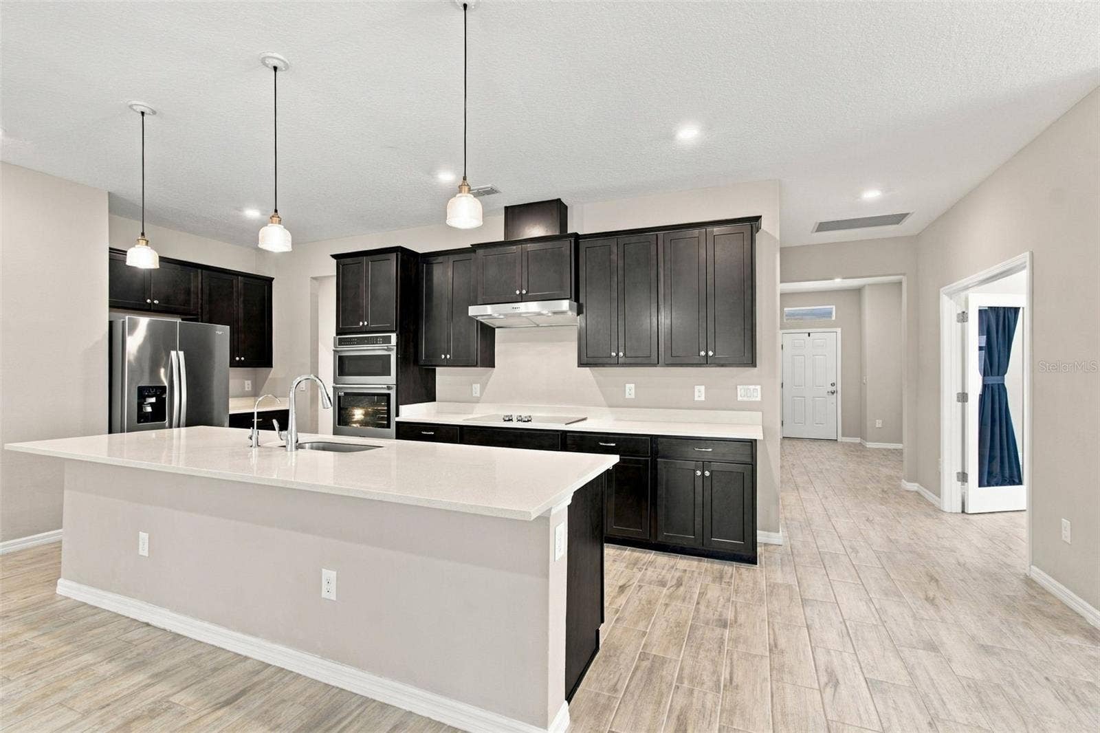 12417 BRICK COBBLESTONE DRIVE, Riverview, FL 33579 Kitchen with front door in the background