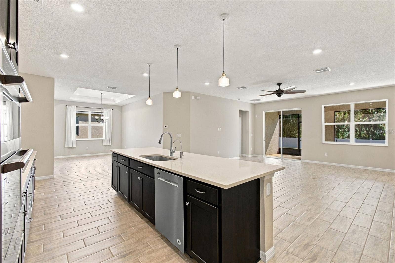 12417 BRICK COBBLESTONE DRIVE, Riverview, FL 33579 Center island with dishwasher - in the background, living room and patio to the right and dining room to the left