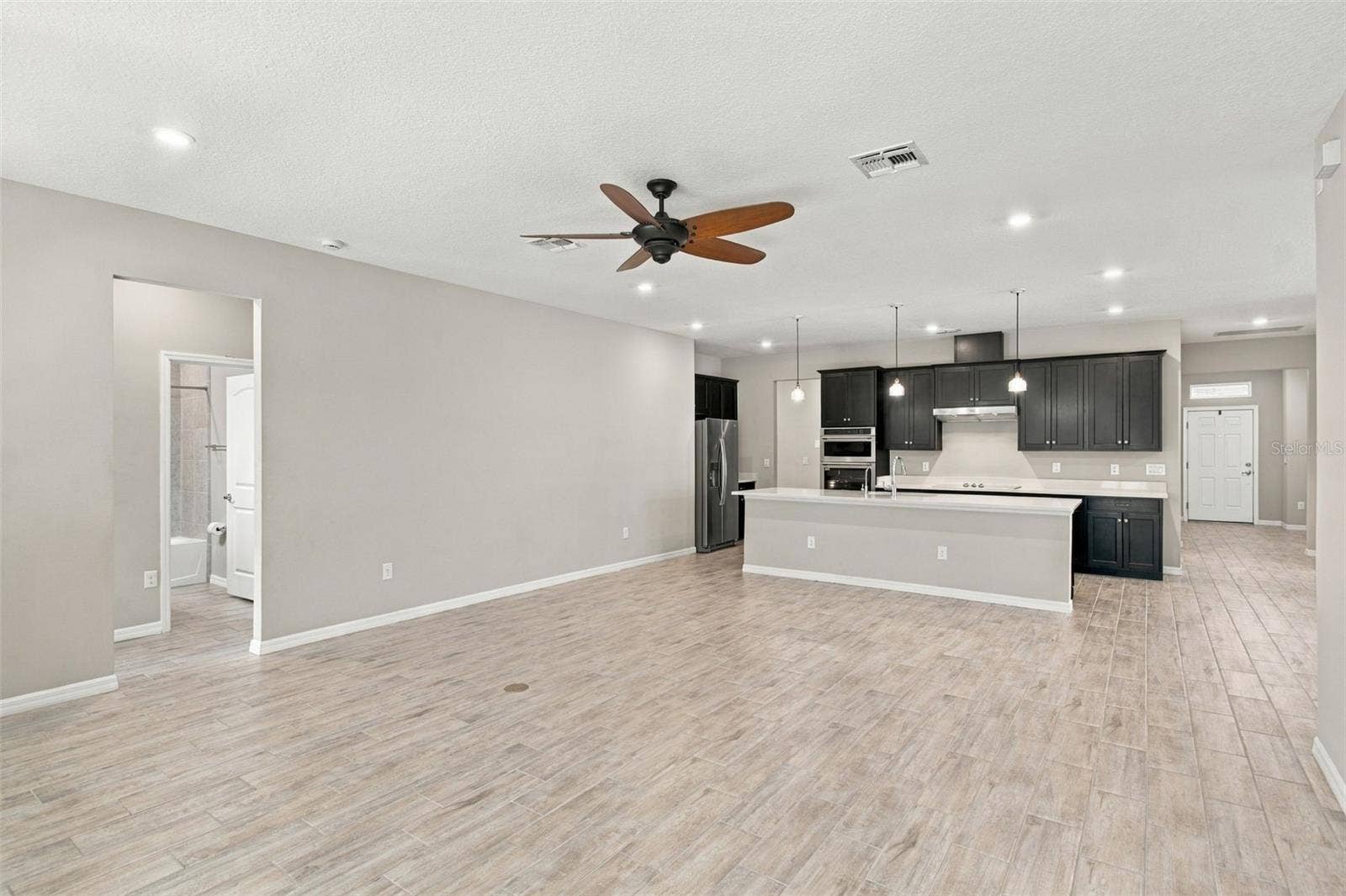 12417 BRICK COBBLESTONE DRIVE, Riverview, FL 33579 Living Room with ceiling fan, Kitchen in background