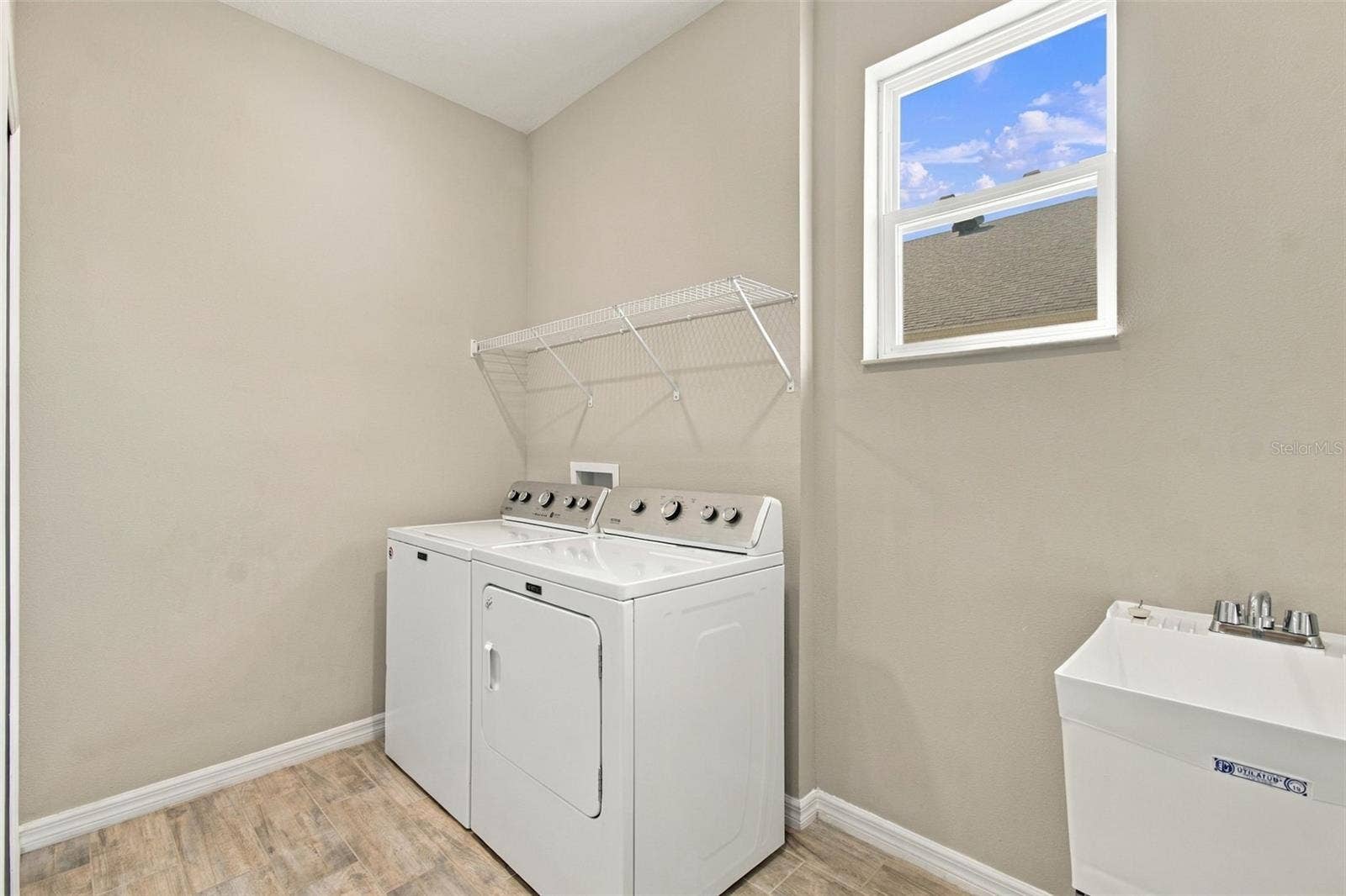 12417 BRICK COBBLESTONE DRIVE, Riverview, FL 33579 Large Laundry Room with deep utility sink and window for natural light- large supply closet to the left (not pictured).