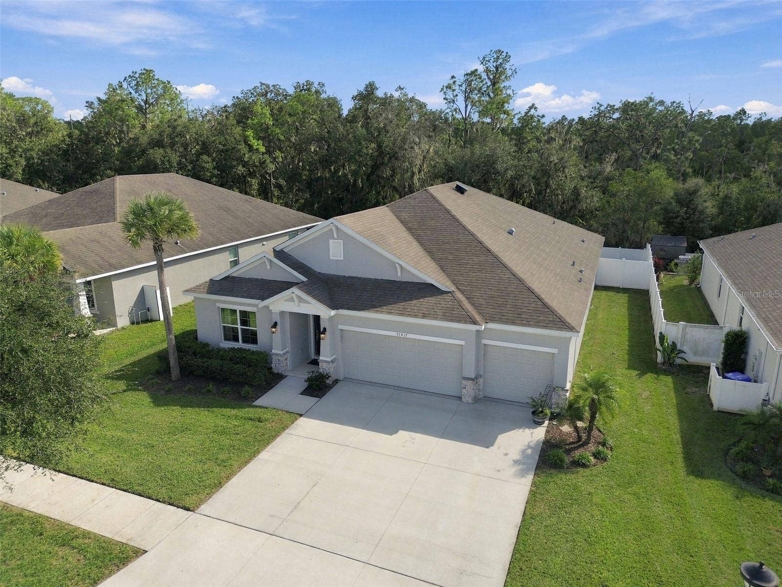 12417 BRICK COBBLESTONE DRIVE, Riverview, FL 33579 Angled overhead view of home's front exterior with conservation in background