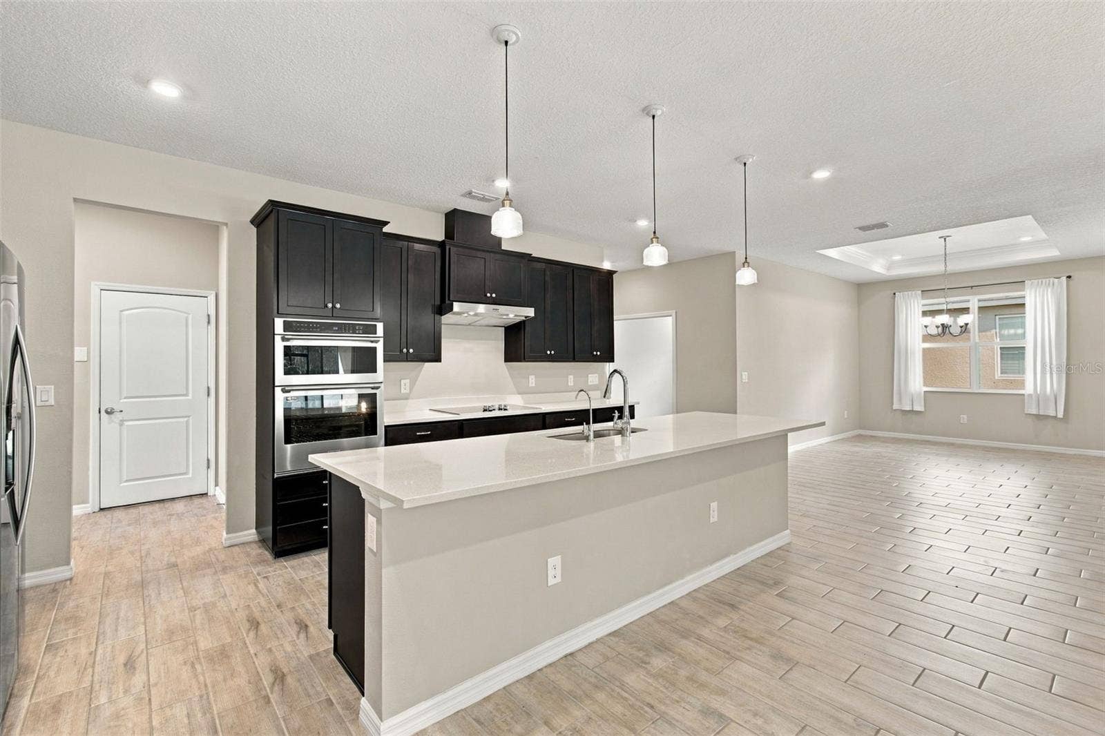 12417 BRICK COBBLESTONE DRIVE, Riverview, FL 33579 Plenty of room for counter stool seating - garage door in background to the left, dining roo to the right