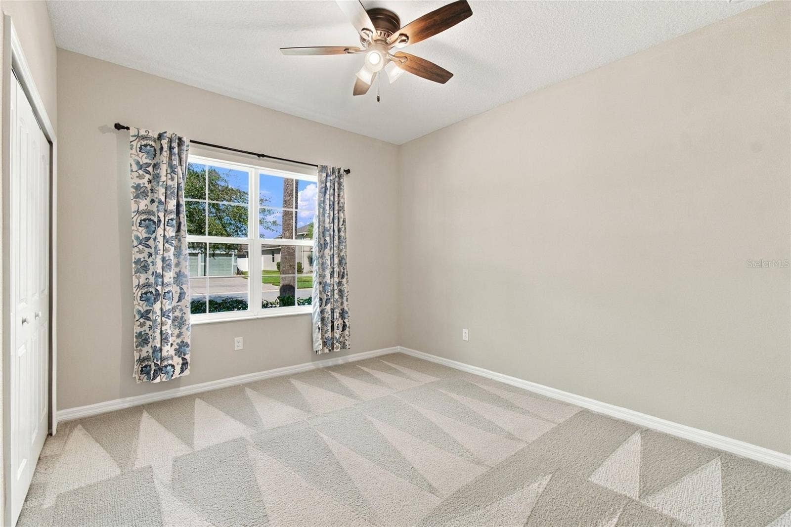 12417 BRICK COBBLESTONE DRIVE, Riverview, FL 33579 Guest bedroom with ceiling fan & large window facing the front yard