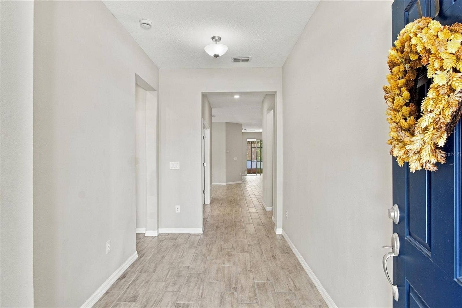 12417 BRICK COBBLESTONE DRIVE, Riverview, FL 33579 Foyer (guest suite entry to your left, followed by the office) - view extends to living room and patio in background