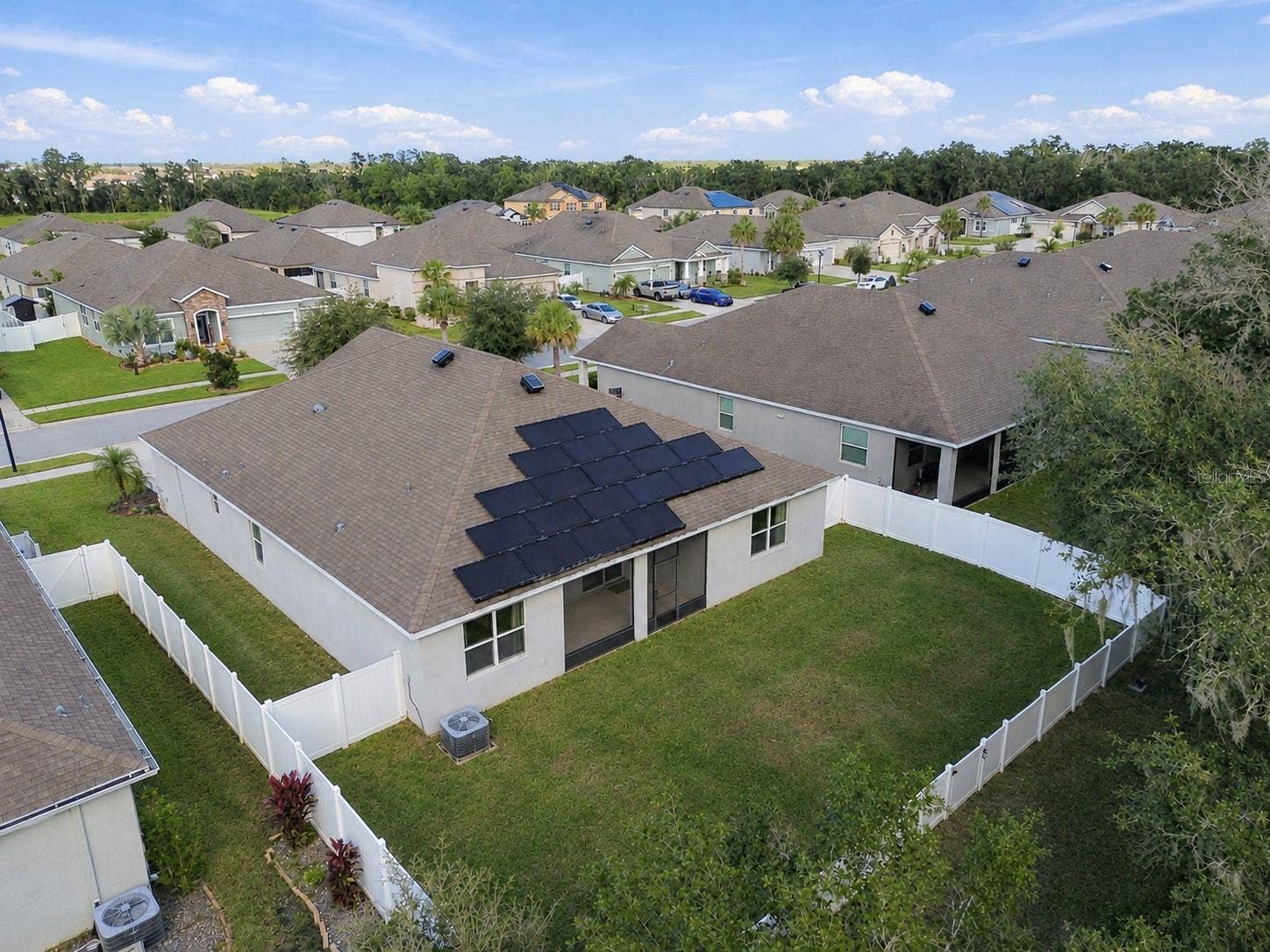 12417 BRICK COBBLESTONE DRIVE, Riverview, FL 33579 Overview of backyard and rear exterior of home by drone - solar panels and solar ventilation on roof