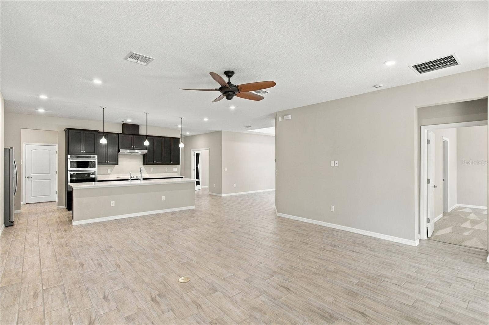 12417 BRICK COBBLESTONE DRIVE, Riverview, FL 33579 Exiting the Primary Suite into the Living Room