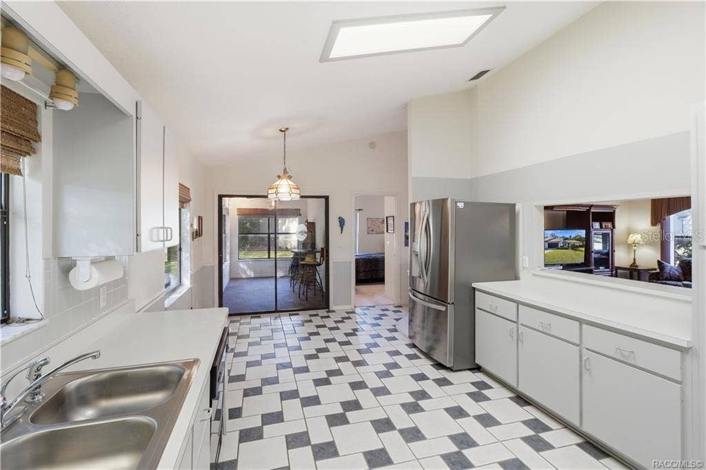 6268 W WESTON DRIVE, Crystal River, FL 34429 THE HEART OF THE HOME! Functional kitchen layout offers GRAY CABINETRY, STAINLESS STEEL REFRIGERATOR, PASS-THROUGH TO LIVING ROOM & convenient access to adjoining spaces!