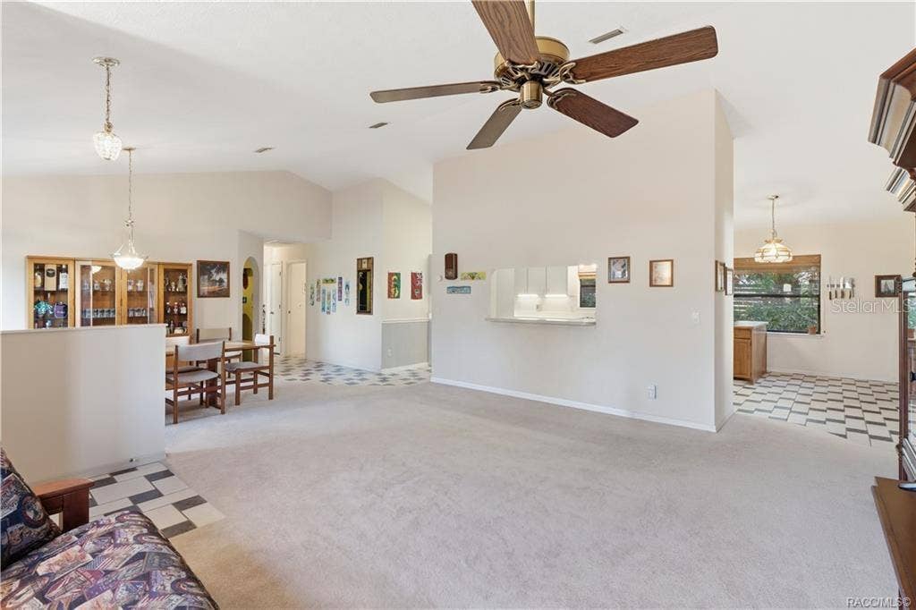 6268 W WESTON DRIVE, Crystal River, FL 34429 OPEN SPACES, ENDLESS POSSIBILITIES! Spacious LIVING ROOM features soaring VAULTED CEILINGS & an OPEN FLOOR PLAN connecting the dining area & kitchen!