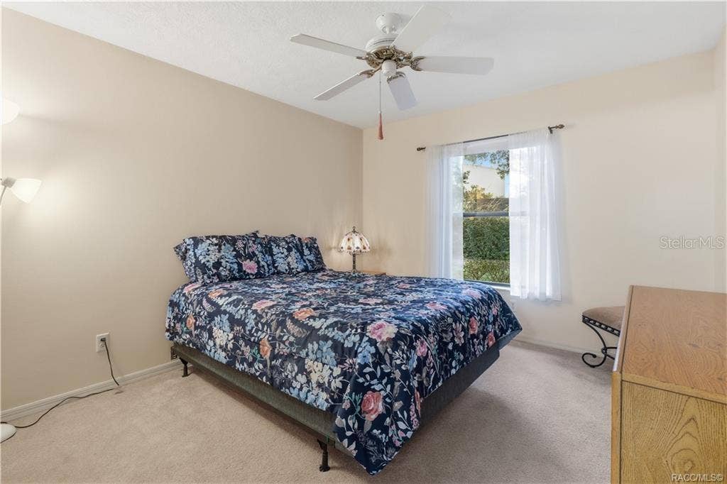 6268 W WESTON DRIVE, Crystal River, FL 34429 SWEET DREAMS! Comfortable GUEST BEDROOM offers neutral carpeting, CEILING FAN & a window overlooking the attractive outdoor greenery!