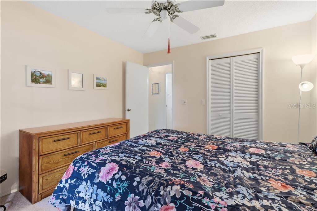 6268 W WESTON DRIVE, Crystal River, FL 34429 Guest bedroom featuring neutral walls, carpeting, ceiling fan and double-door closet.