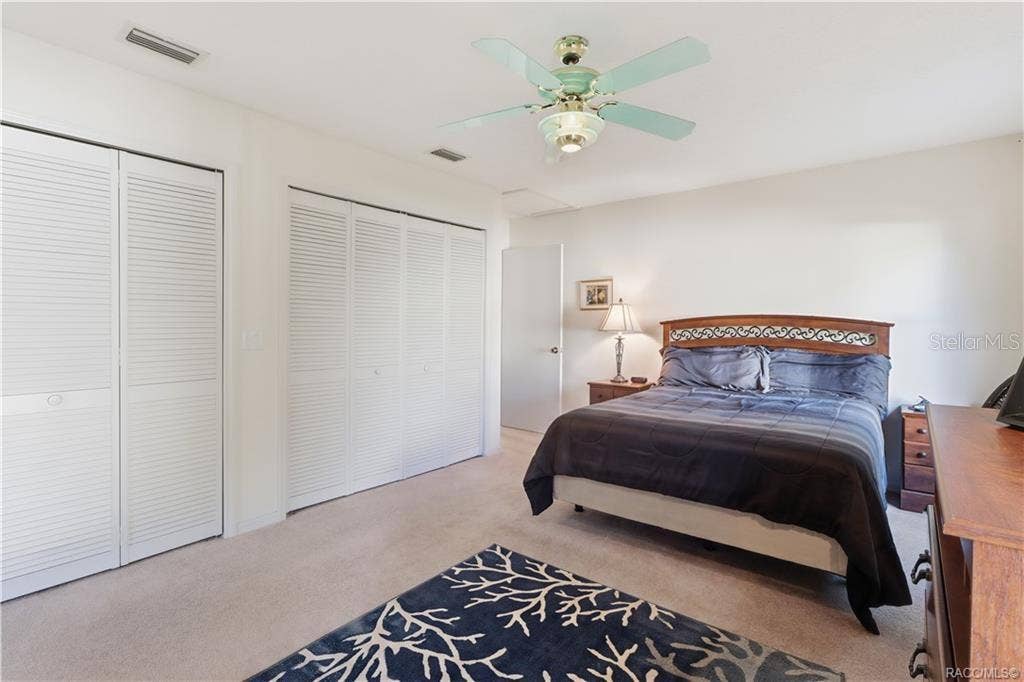 6268 W WESTON DRIVE, Crystal River, FL 34429 ROOM TO RELAX! PRIMARY SUITE features GENEROUS CLOSET SPACE w/multiple louvered closet doors, soft neutral carpeting & ceiling fan!