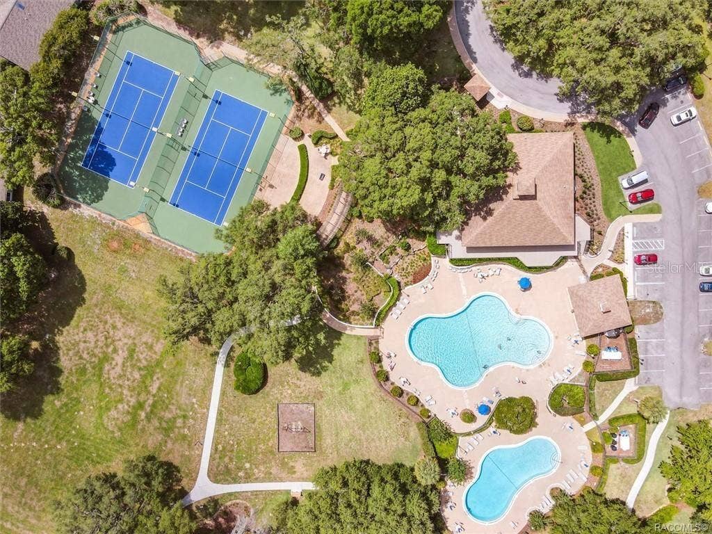 6268 W WESTON DRIVE, Crystal River, FL 34429 RECREATIONAL AMENITIESRESORT-STYLE RECREATION AT YOUR FINGERTIPS! An impressive aerial view showcasing Meadowcrest's TWO COMMUNITY POOLS, TENNIS COURTS, clubhouse area & beautifully landscaped recreational grounds!