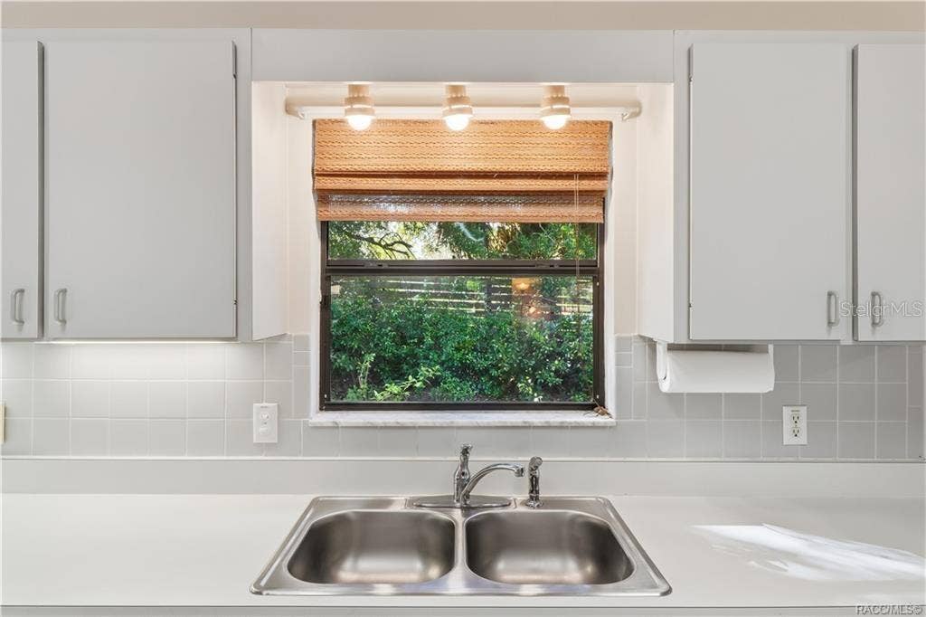 6268 W WESTON DRIVE, Crystal River, FL 34429 EVERYTHING IN ITS PLACE! Kitchen DOUBLE-BASIN STAINLESS STEEL SINK is perfectly positioned beneath a window overlooking the greenery!