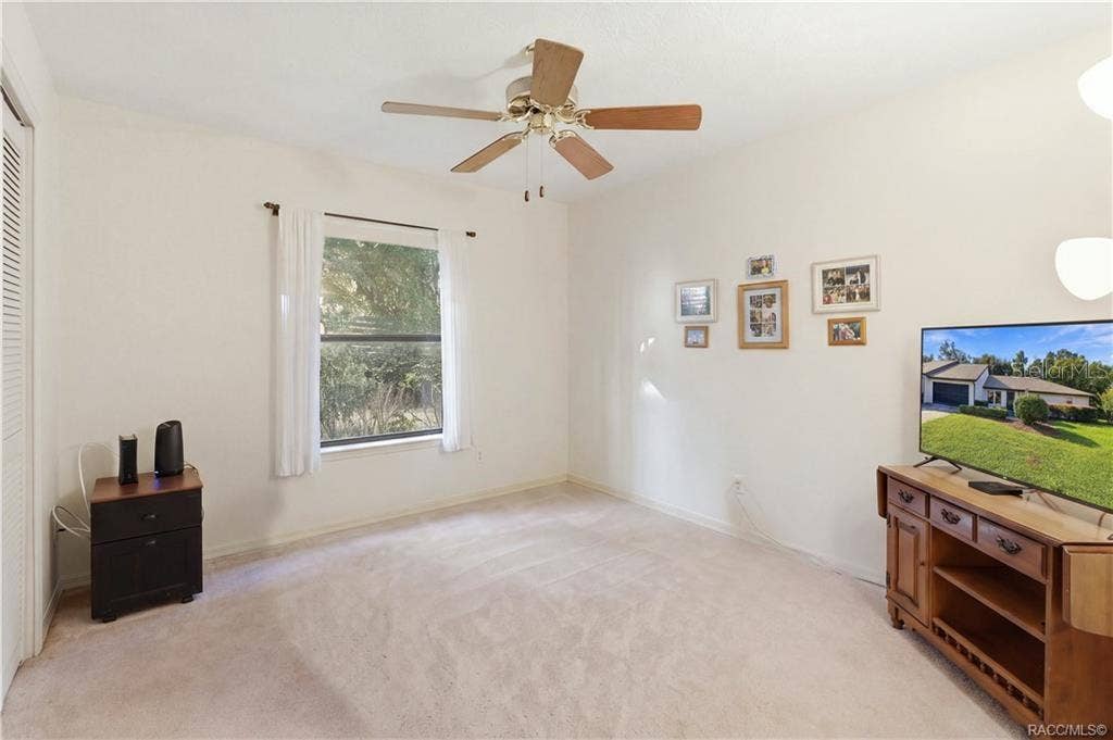 6268 W WESTON DRIVE, Crystal River, FL 34429 Additional view of the guest bedroom showcasing natural light, ceiling fan, carpeting.