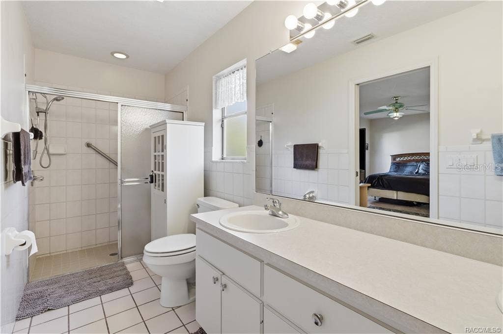 6268 W WESTON DRIVE, Crystal River, FL 34429 EVERYDAY COMFORT! PRIMARY BATH features a spacious VANITY, LARGE MIRROR, WALK-IN SHOWER & convenient storage!