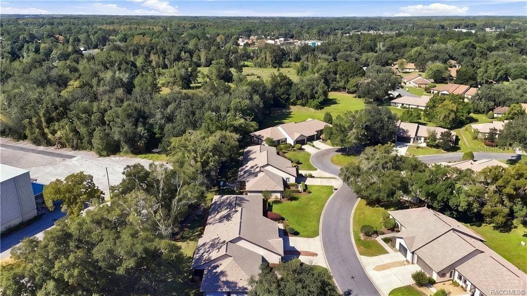 6268 W WESTON DRIVE, Crystal River, FL 34429 AERIAL VIEW OF COMMUNITYEnjoy an aerial perspective of this established residential community, featuring winding streets, mature trees, attractive homes, and beautifully maintained green spaces.