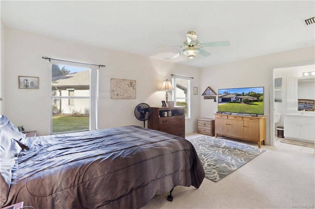 6268 W WESTON DRIVE, Crystal River, FL 34429 YOUR OWN PRIVATE RETREAT! Spacious PRIMARY BEDROOM offers comfortable surroundings, TWO WINDOWS, CEILING FAN & convenient access to the EN-SUITE BATH!