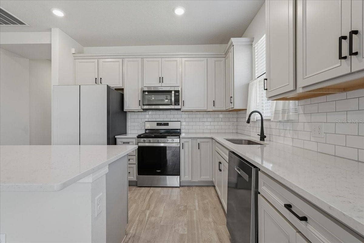 Kitchen - Tall Crown Molding on Cabinetry, 42" Uppers, Wastebasket pull out, Soft Close Drawers, Double Roll-Out Trays