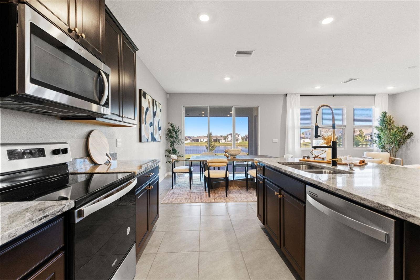 Kitchen toward dining and pond - 5126 Jackel Chase Dr, Wimauma