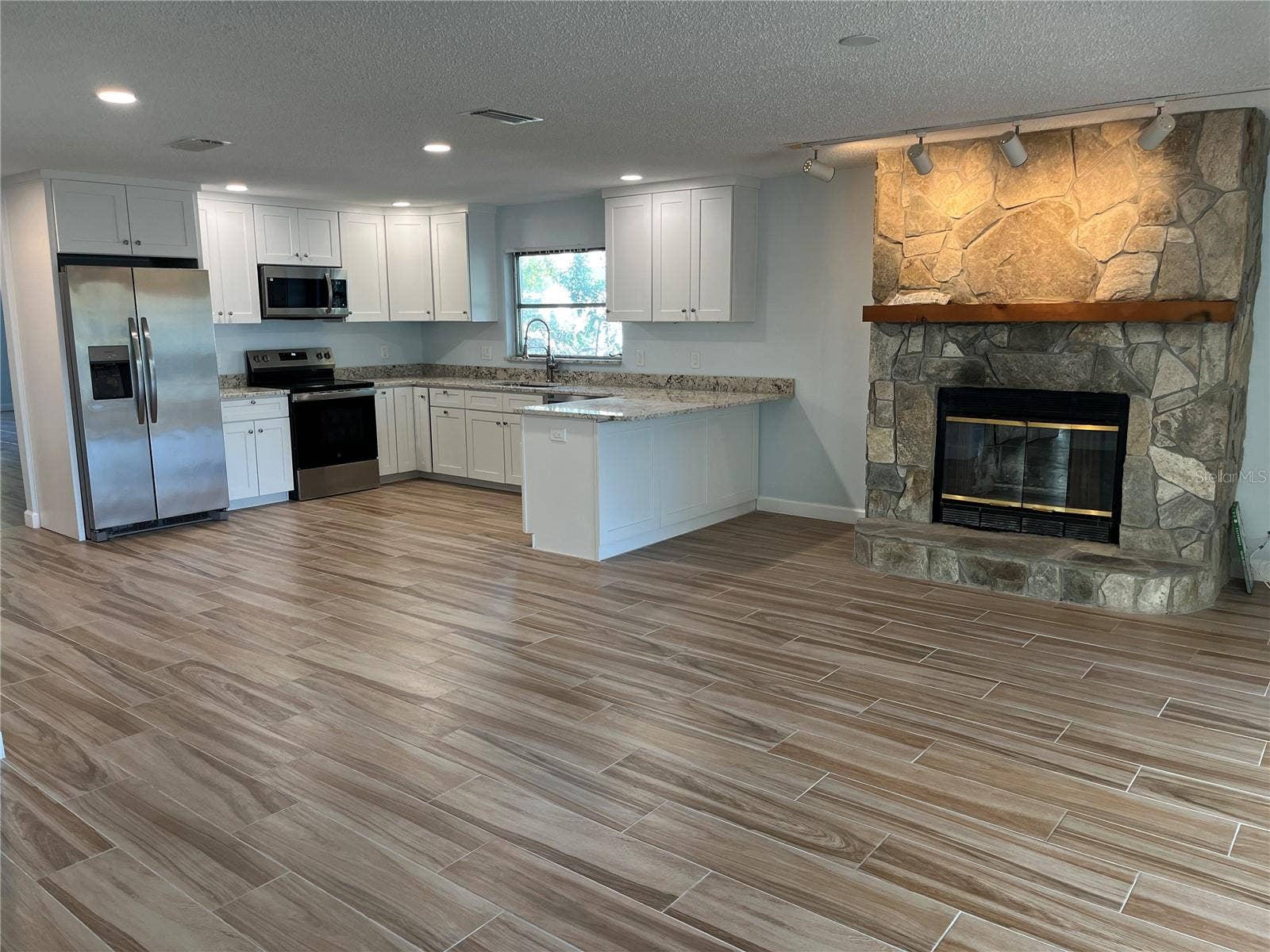 307 LA HACIENDA DRIVE, Indian Rocks Beach, FL 33785 Kitchen and fireplace