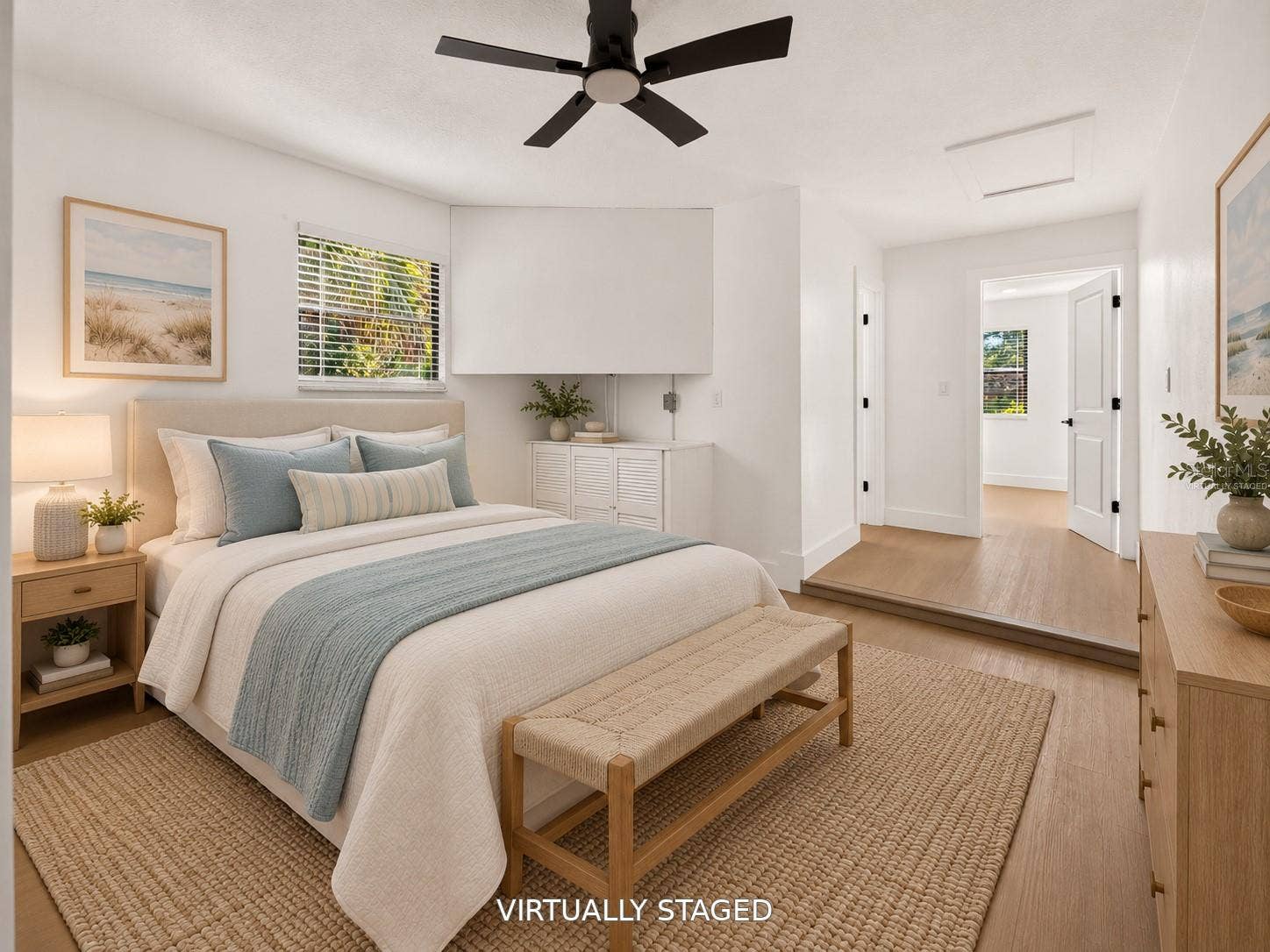16107 SEA PINES DRIVE, Hudson, FL 34667 VIRTUALLY STAGED. Bright secondary bedroom featuring updated flooring and a modern black ceiling fan.