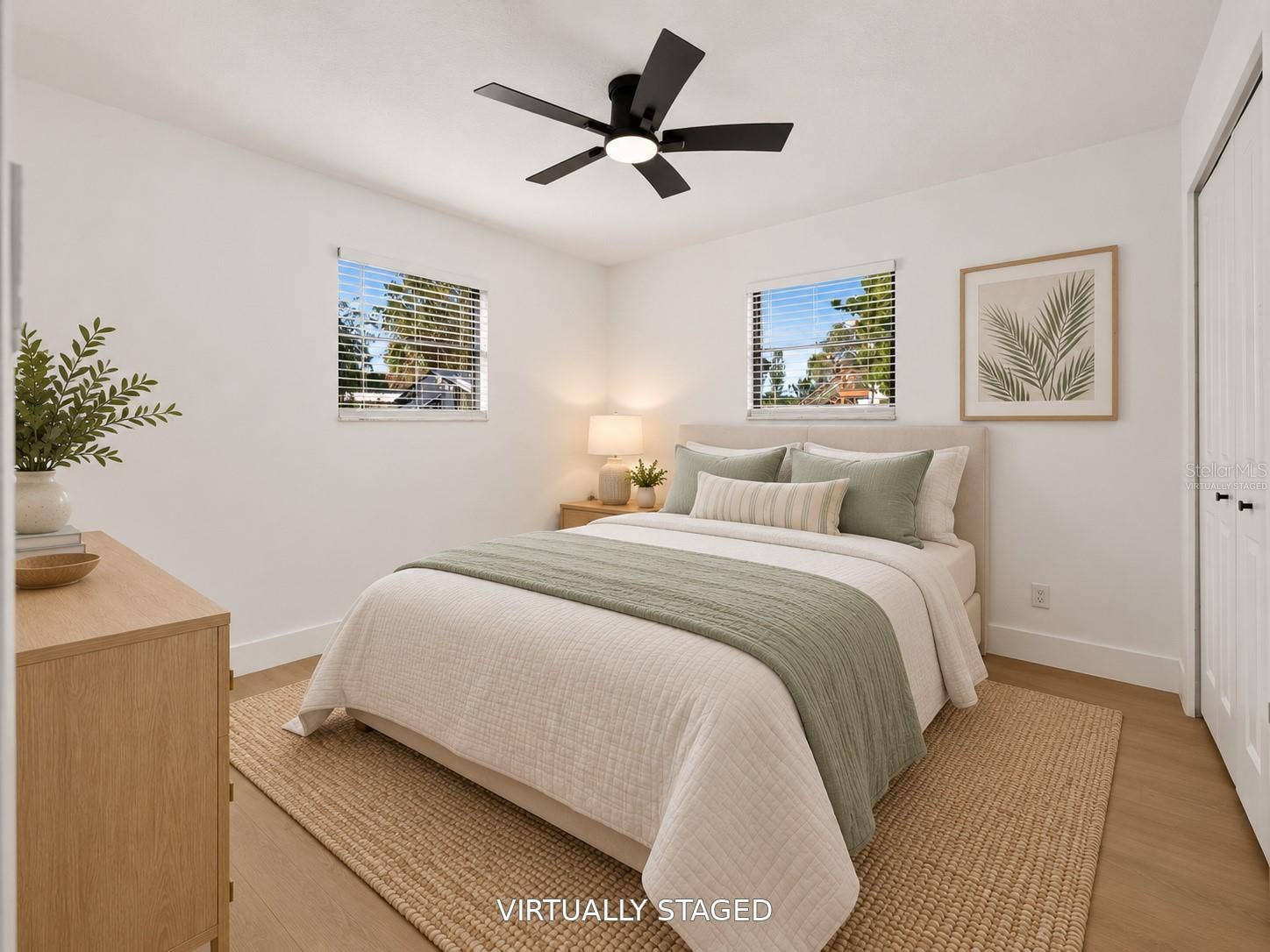 16107 SEA PINES DRIVE, Hudson, FL 34667 VIRTUALLY STAGED. Additional bedroom featuring a sleek black ceiling fan and updated flooring.
