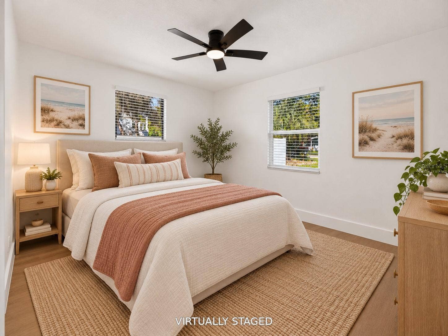 16107 SEA PINES DRIVE, Hudson, FL 34667 VIRTUALLY STAGED. Bright secondary bedroom featuring updated flooring and a modern black ceiling fan.