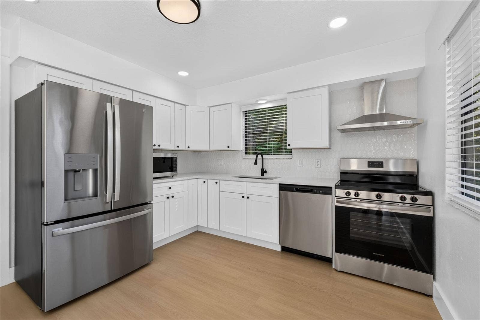 16107 SEA PINES DRIVE, Hudson, FL 34667 Updated kitchen featuring quartz countertops and stainless steel appliances.
