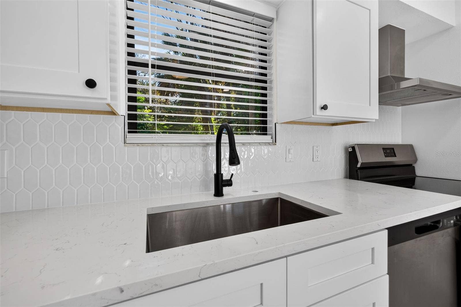 16107 SEA PINES DRIVE, Hudson, FL 34667 Bright white cabinetry, quartz countertops, and stylish finishes.