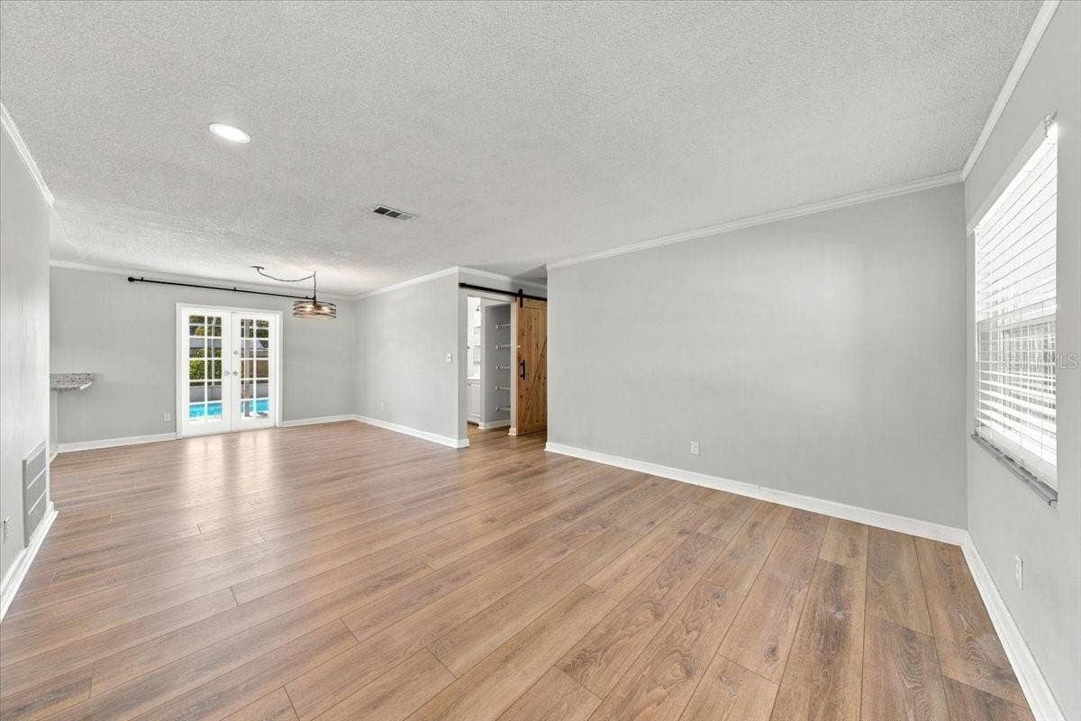 5220 90TH TERRACE N, Pinellas Park, FL 33782 Living room and dining area with french doors to the pool