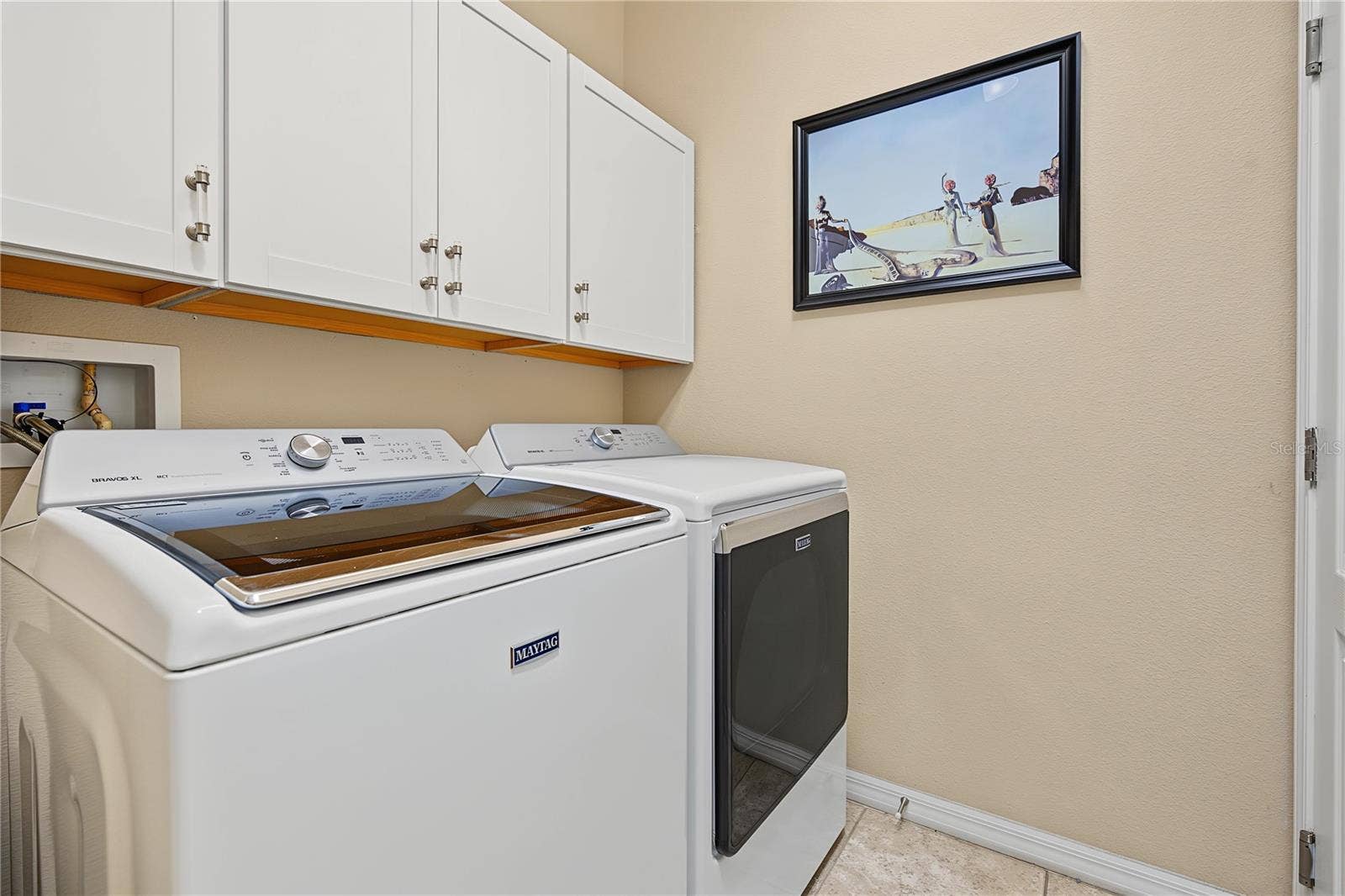 29145 GRASS BUNKER DRIVE, San Antonio, FL 33576 Interior laundry room with storage cabinets above