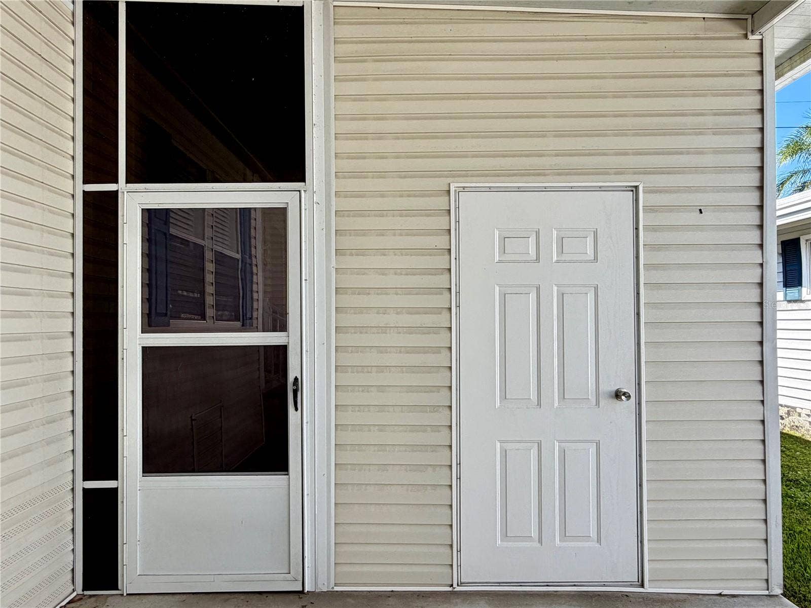 34012 AZALEA DRIVE N, Pinellas Park, FL 33781 Door on right is the storage shed, door on left leads to the Sunroom