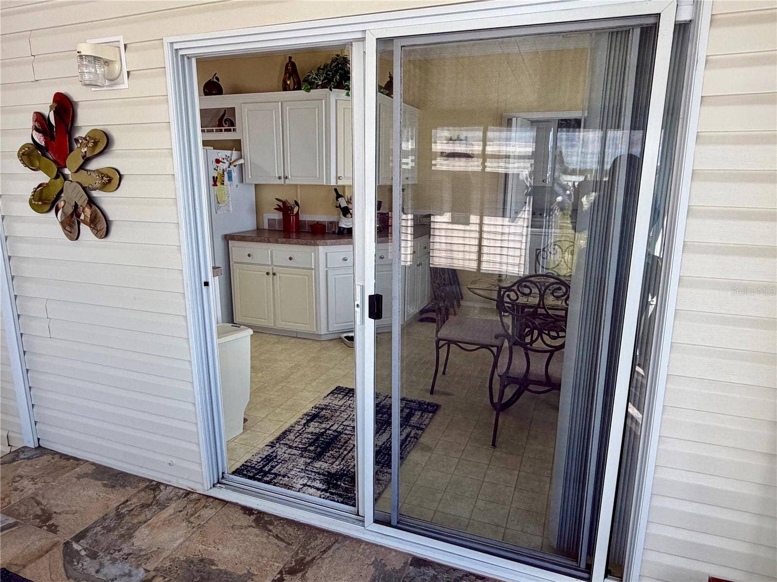 34012 AZALEA DRIVE N, Pinellas Park, FL 33781 Sliding doors lead to the kitchen