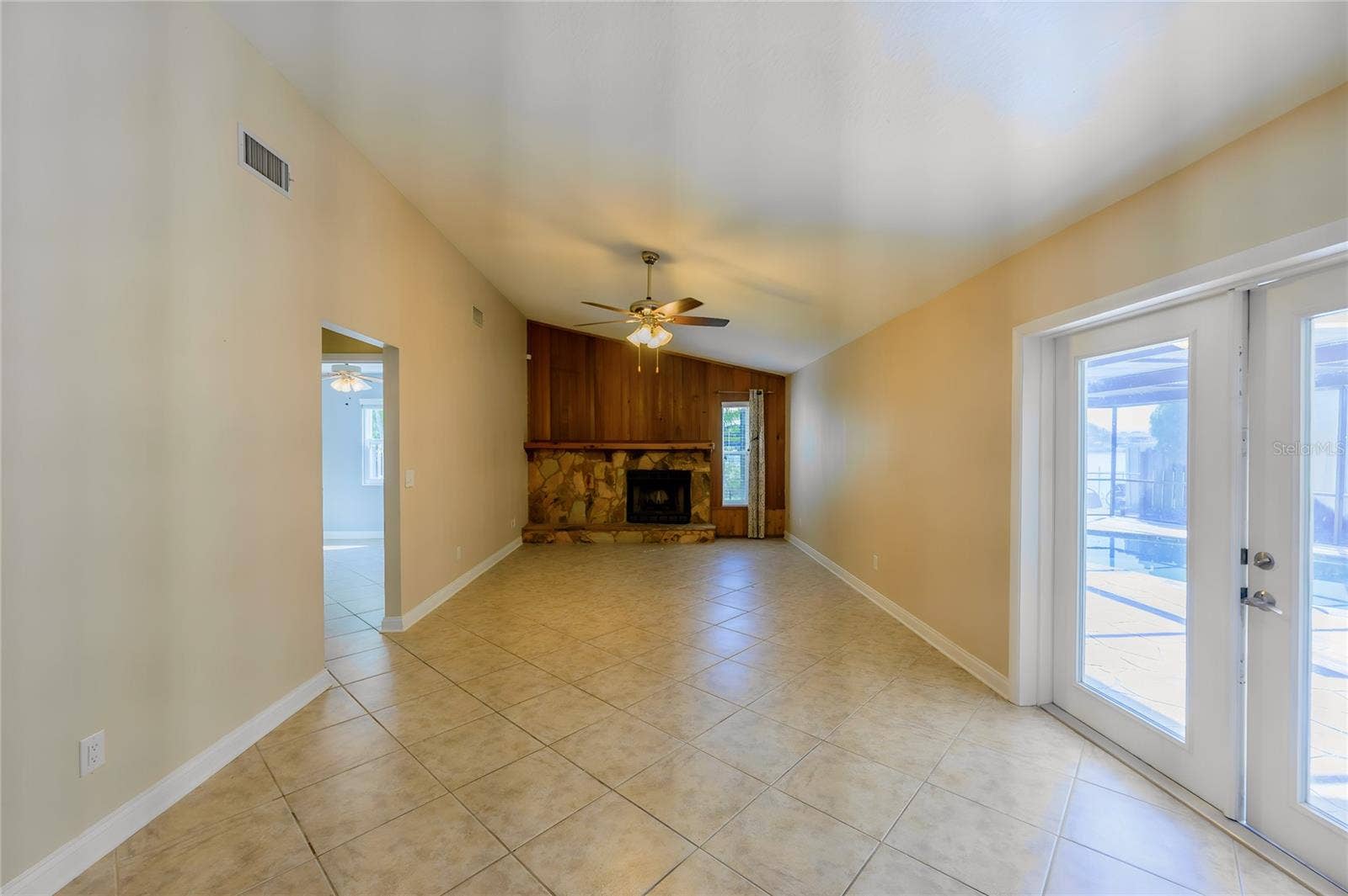 12173 WILD ACRES ROAD, Largo, FL 33773 Family room with French doors leading to screen enclosed pool