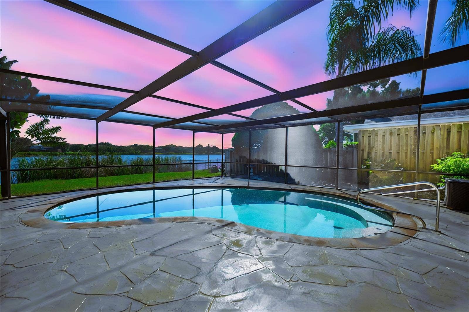 12173 WILD ACRES ROAD, Largo, FL 33773 Relax is your private salt water pool safe from mosquitos in your screen enclosed retreat overlooking the Lake