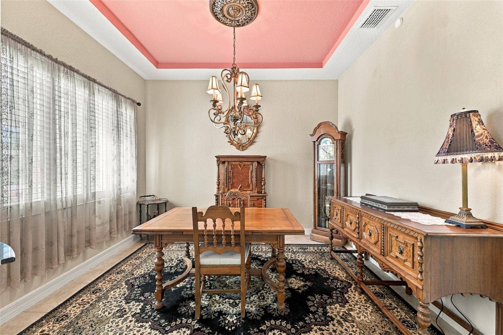 The dining room is spacious and perfect for a quiet dinner with friends and family, while also being open to the rest of the home.  Notice the tray ceiling.