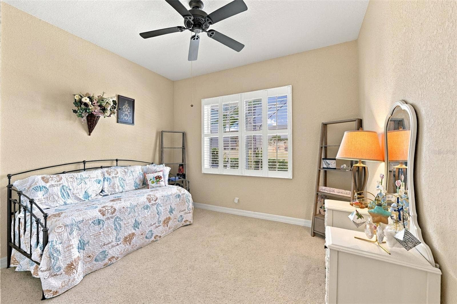 Bedroom #3 is on the opposite side of the house with a view to the pool area.  Plantations shutters make this a very relaxing and enjoyable space.