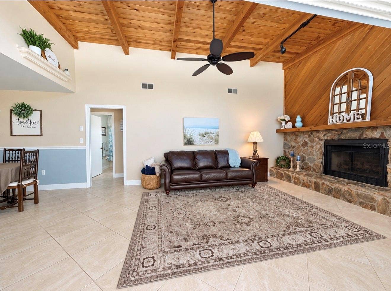 9690 LEEWARD AVENUE, Largo, FL 33773 Family room with natural light and fireplace off 2nd and 3rd bedroom hallway