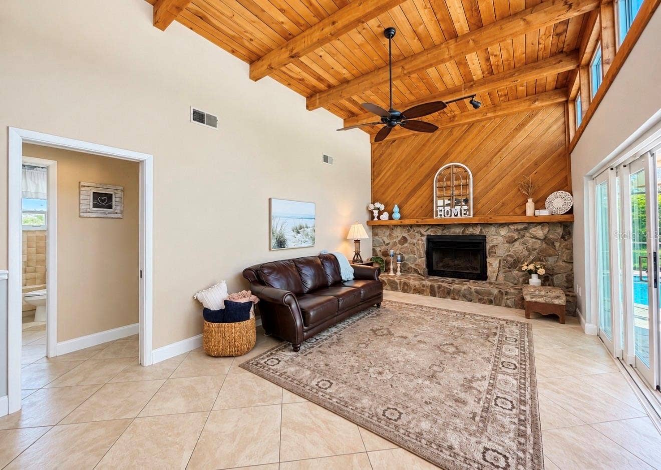 9690 LEEWARD AVENUE, Largo, FL 33773 Family room with natural light and fireplace off 2nd and 3rd bedroom hallway