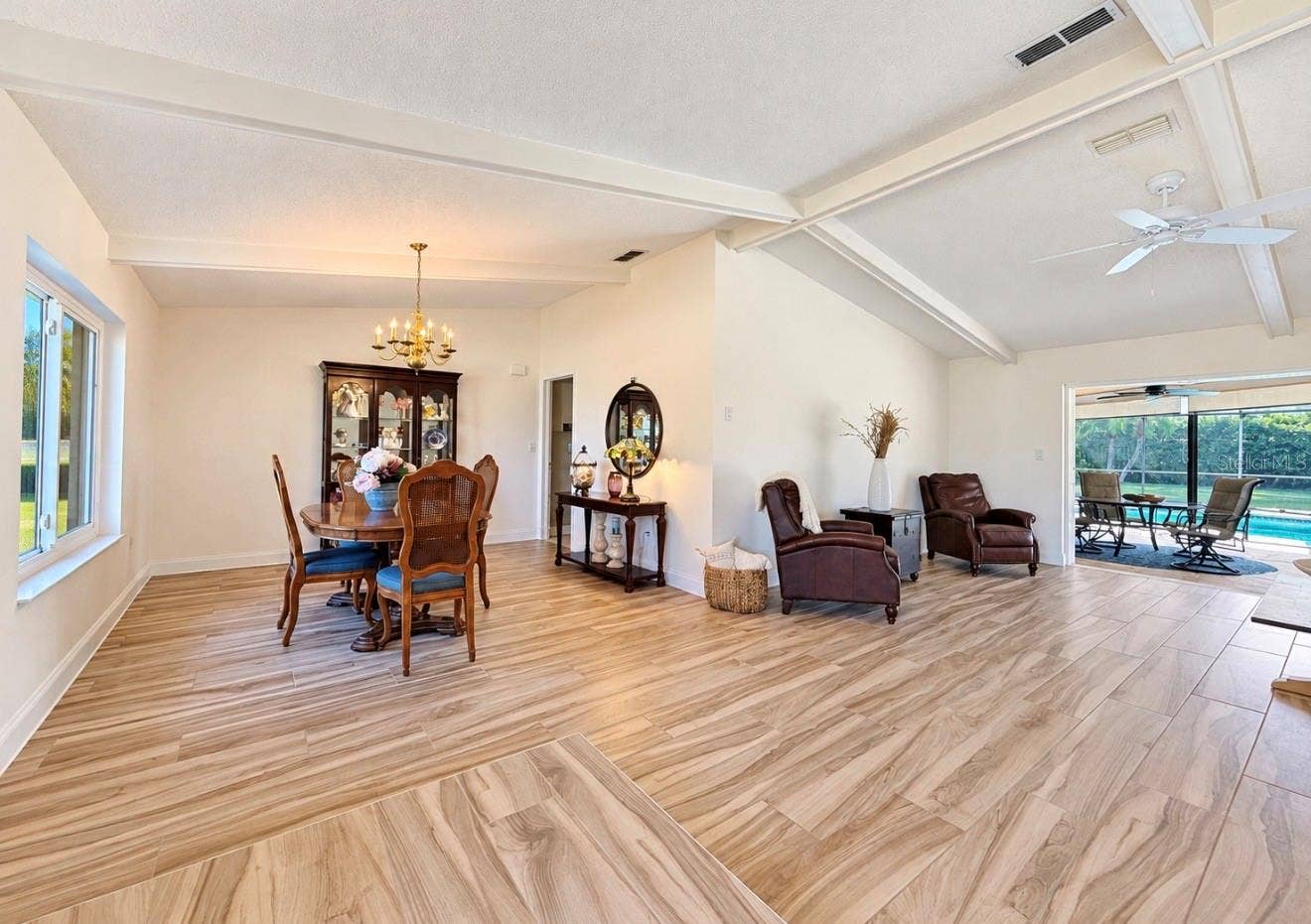 9690 LEEWARD AVENUE, Largo, FL 33773 open dining living area leads to pool lanai