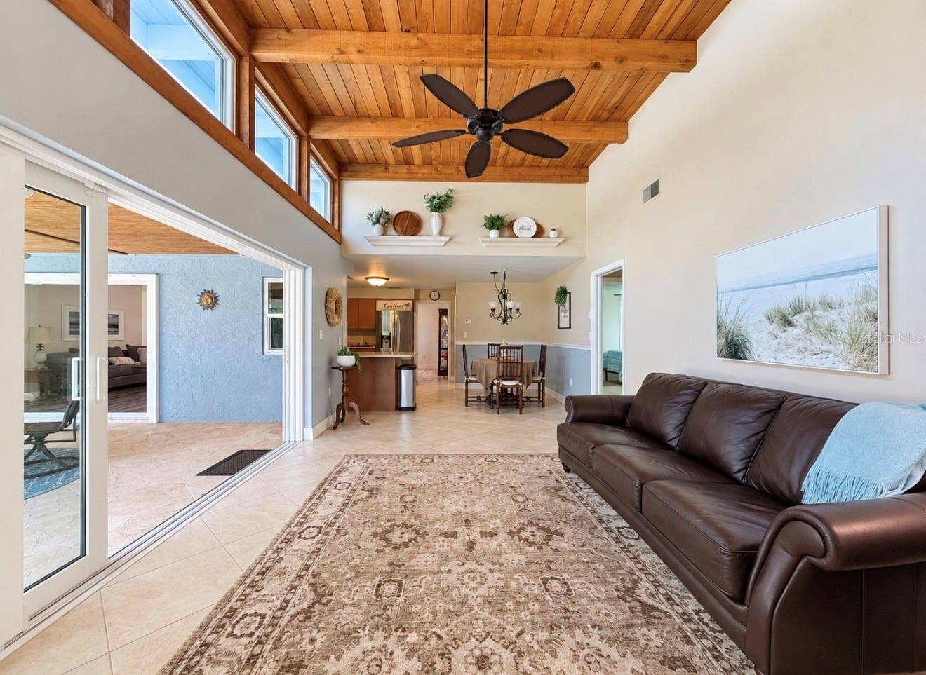 9690 LEEWARD AVENUE, Largo, FL 33773 Family room with natural light and fireplace off 2nd and 3rd bedroom hallway