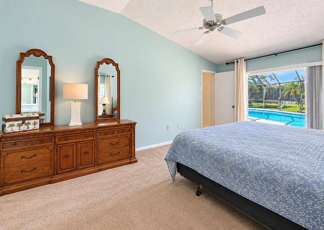 9690 LEEWARD AVENUE, Largo, FL 33773 Primary bedroom leads to pool lanai